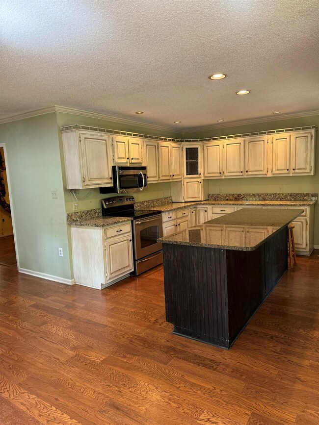 Kitchen with dark wood-type flooring, ornamental m