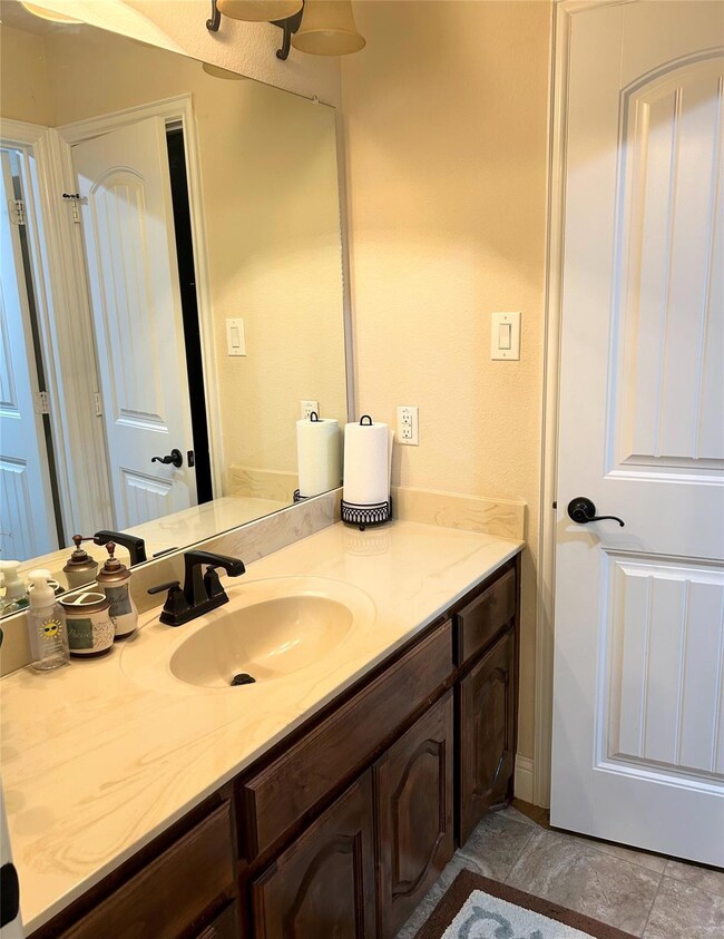 Bathroom featuring vanity and tile floors