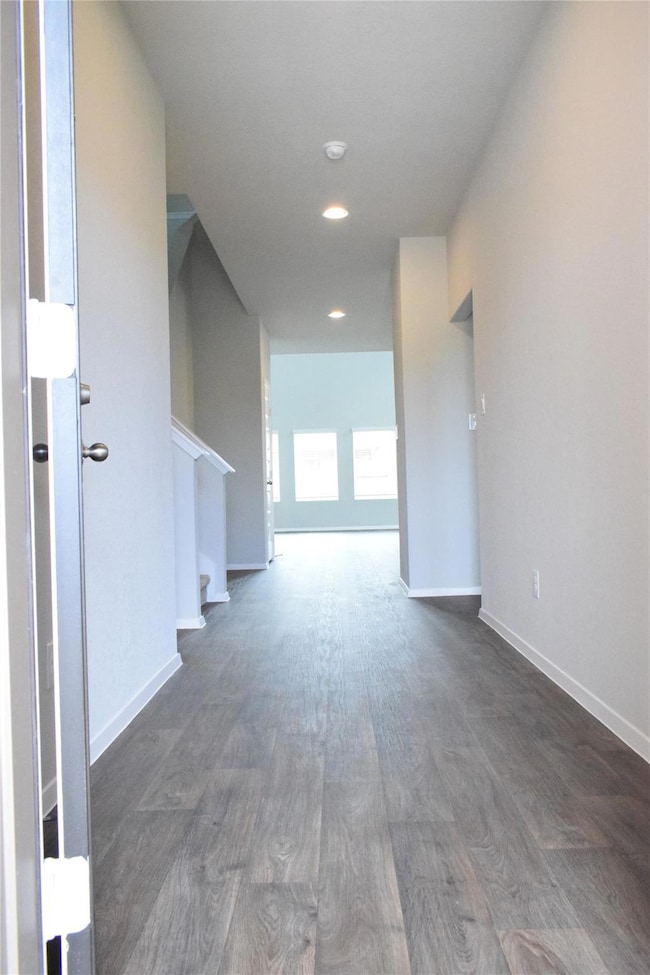 Corridor with dark wood-style flooring, recessed 