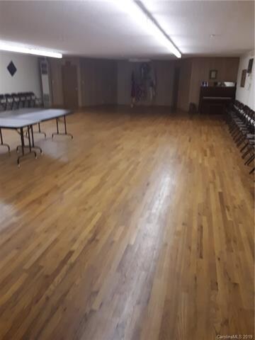 Longer view of hall with tables and chairs if need