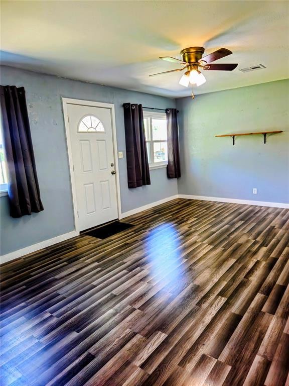 Spacious living room with great natural sunlight, wood style finished floors, and ceiling fan.