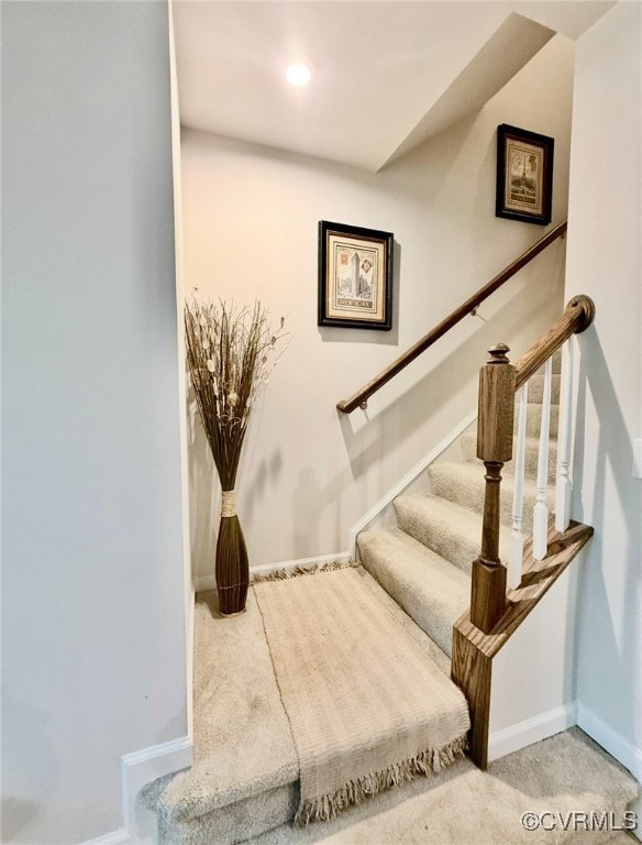 Stairs with carpet and recessed lighting