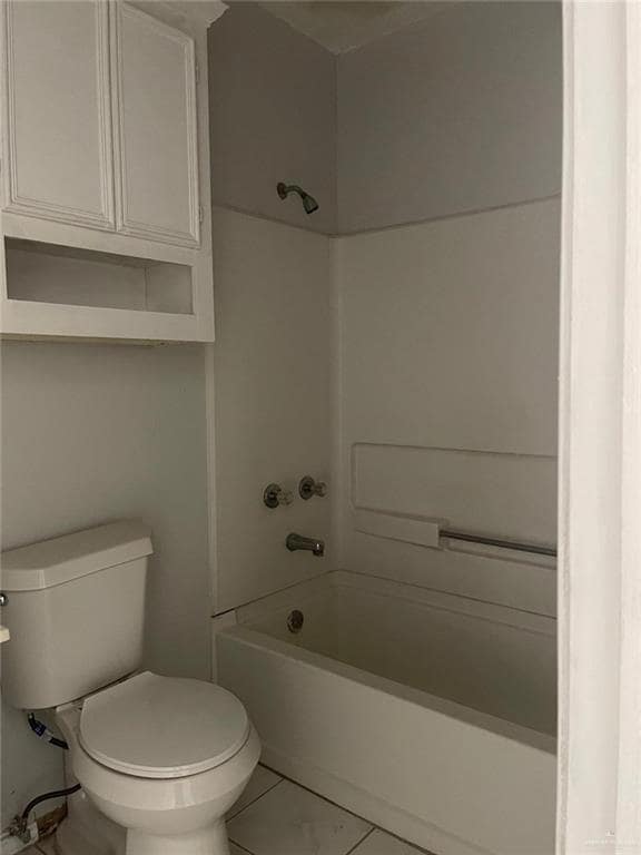 Bathroom with bathing tub / shower combination and tile patterned flooring