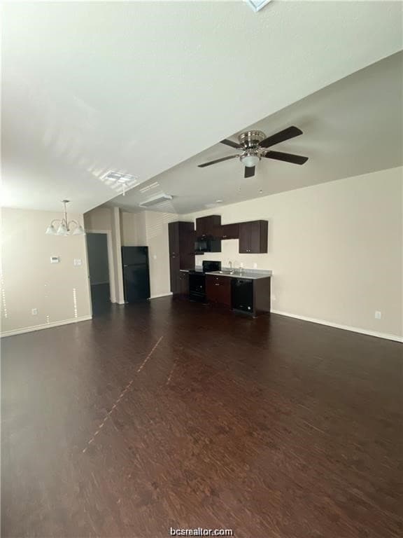 Unfurnished living room featuring a sink, baseboar
