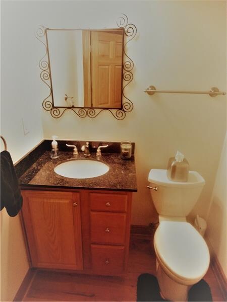 The powder room sits just off of the living room, 