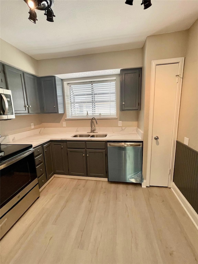 Kitchen featuring sink, appliances with stainless 