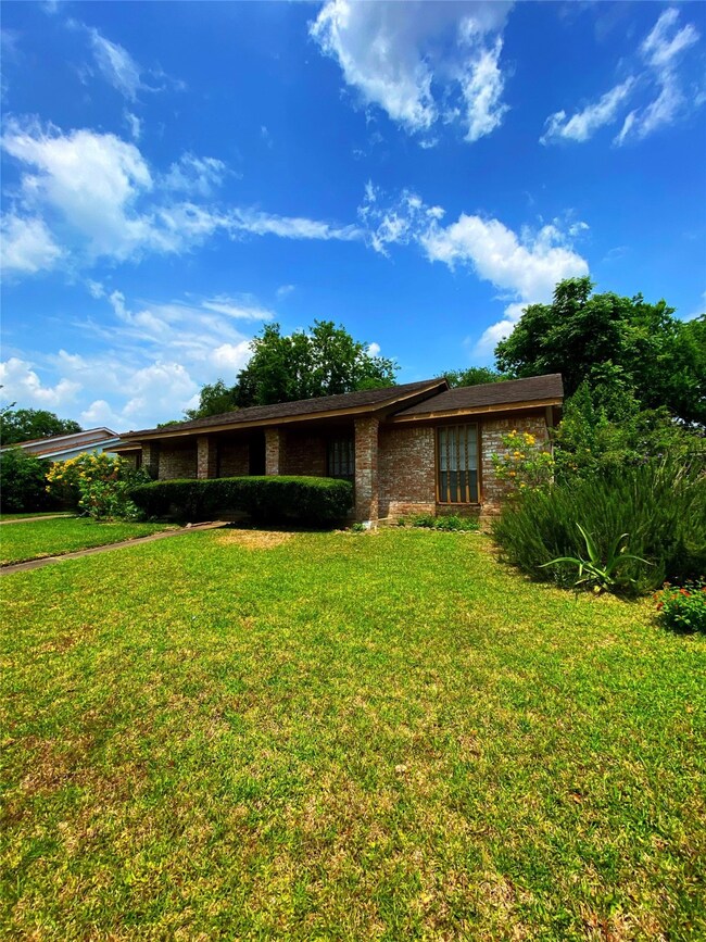 The view from the right side of the property. The porch is not as dark as this picture indicates. I was concentrating on the lovely blue sky while manipulating the picture and I ignored the dark porch.