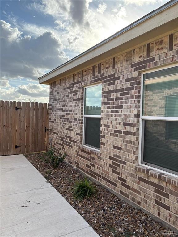 View of side of home with brick siding