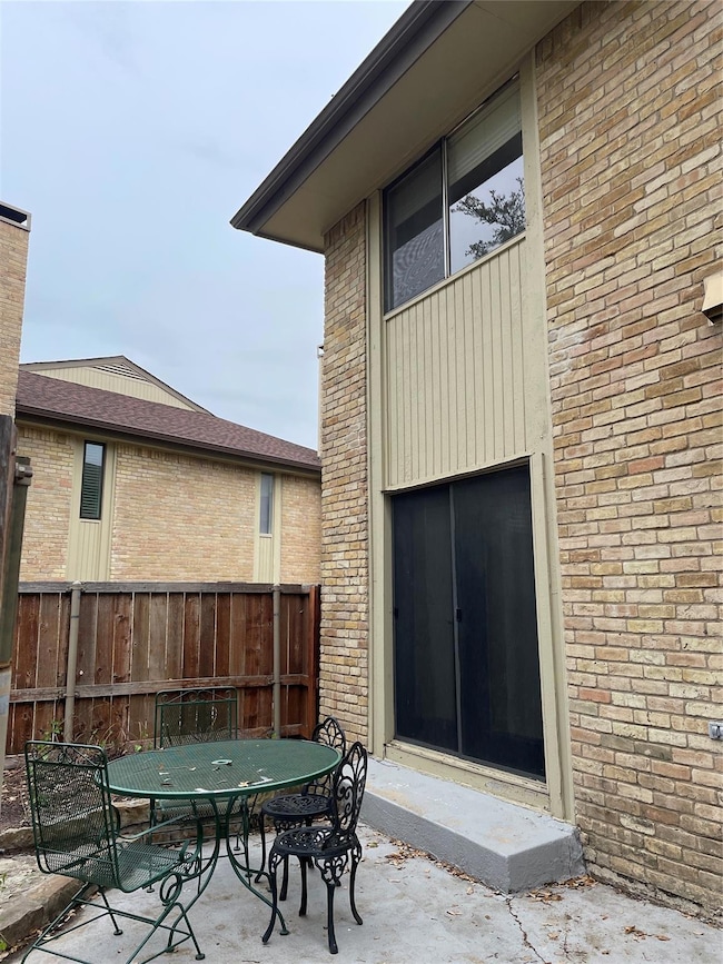 View of patio with fence
