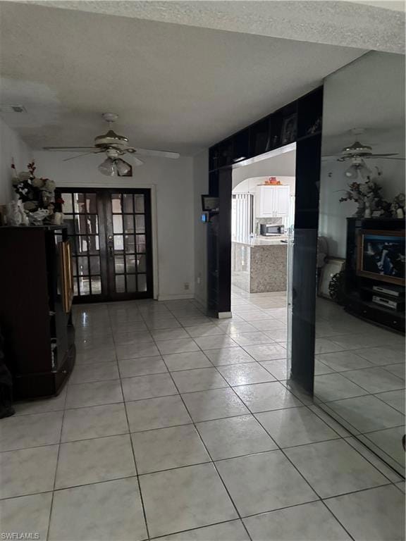 Unfurnished living room featuring light tile patte