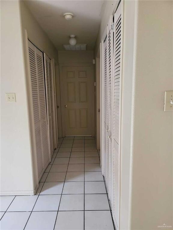 Corridor featuring light tile patterned flooring and visible vents