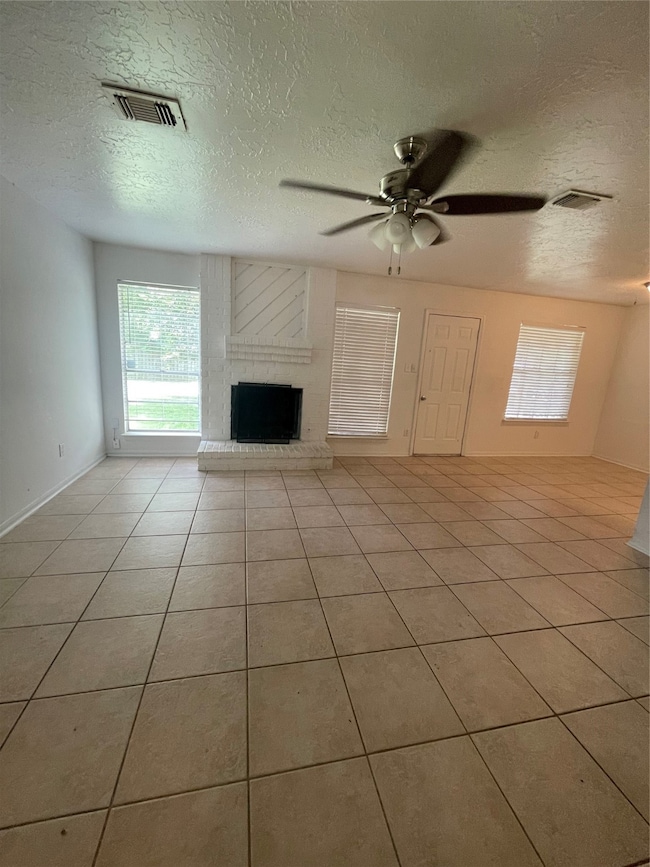 Spacious living room with tiled flooring, featurin