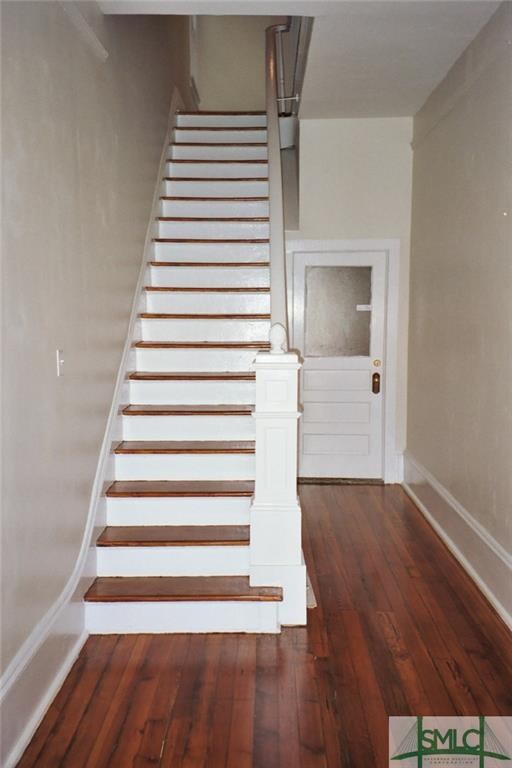 One of three doors to bottom apartment. Stairs to 
