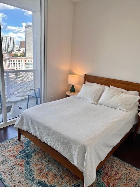 Bedroom with a city view and wood finished floors