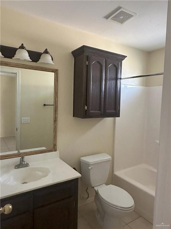 Full bathroom with tile patterned flooring, bathtub / shower combination, vanity, and toilet