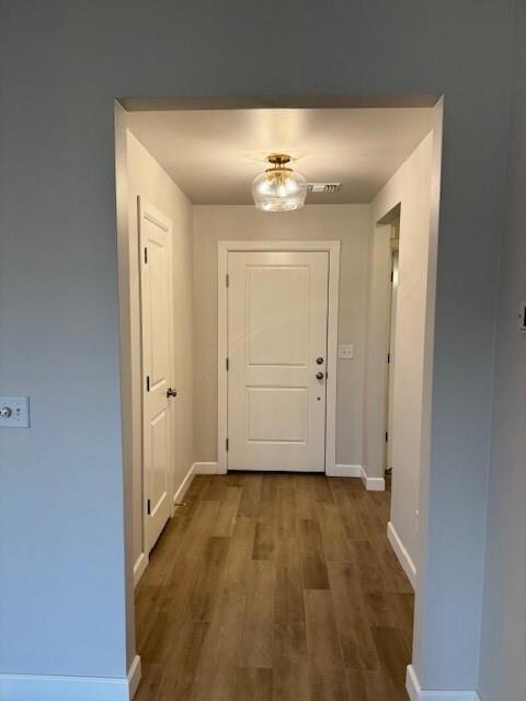 Hall featuring dark wood-type flooring