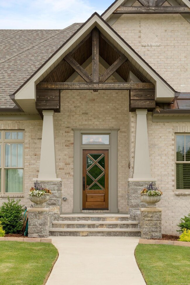 Cedar stained accents with real stone and brick used to limit home maintenance.