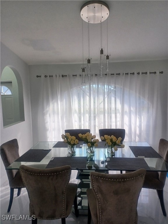 Dining area featuring arched walkways and marble f