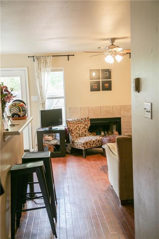 Living room featuring ceiling fan, hardwood / woo