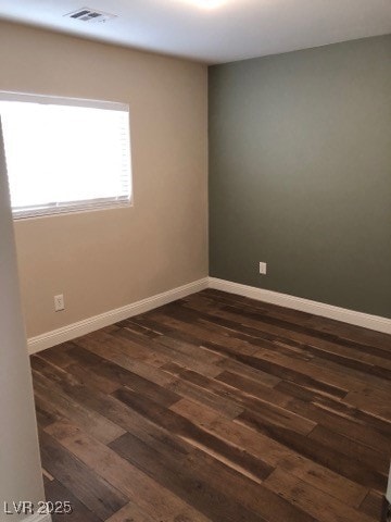 Spare room with dark wood-type flooring