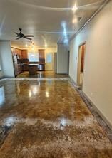 Unfurnished living room with ceiling fan