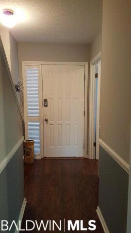 Foyer with access to kitchen, laundry & powder room shows stairs to 2nd floor on left