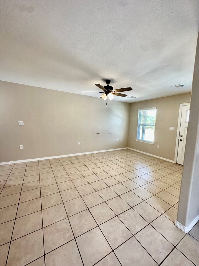 This home showcases tile throughout, 2 inch faux blinds and a ceiling fans.