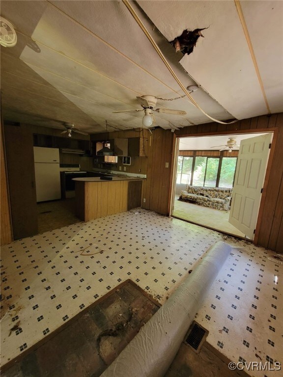 Kitchen featuring white fridge, wall chimney exhau