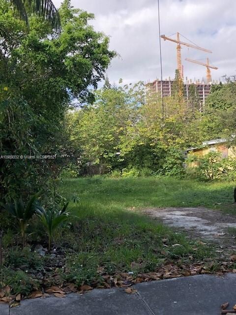 Build-able lot to accommodate 2 town homes, with Coral Gables construction in the distance
