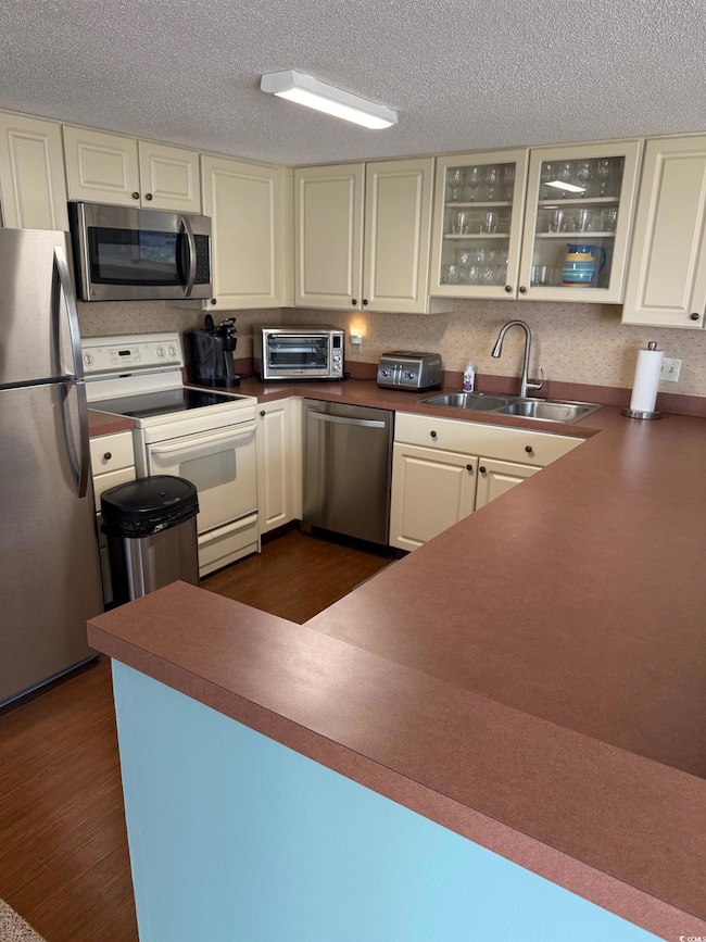 Kitchen featuring a toaster, glass insert cabinets