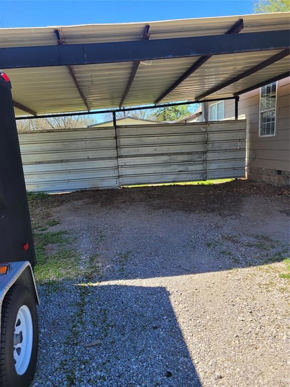 Garage featuring a carport