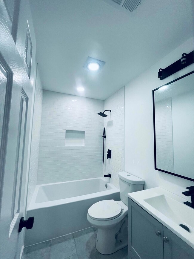 Full bathroom featuring vanity, shower / bath combination, and tile patterned floors