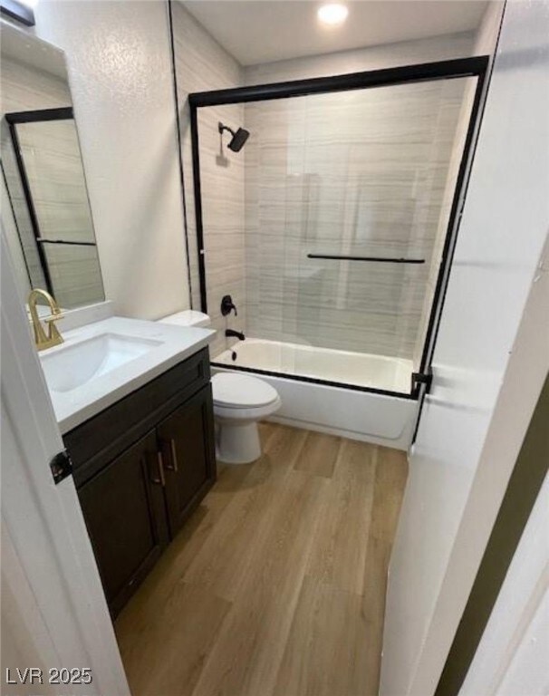 Full bath with vanity, wood finished floors, and s