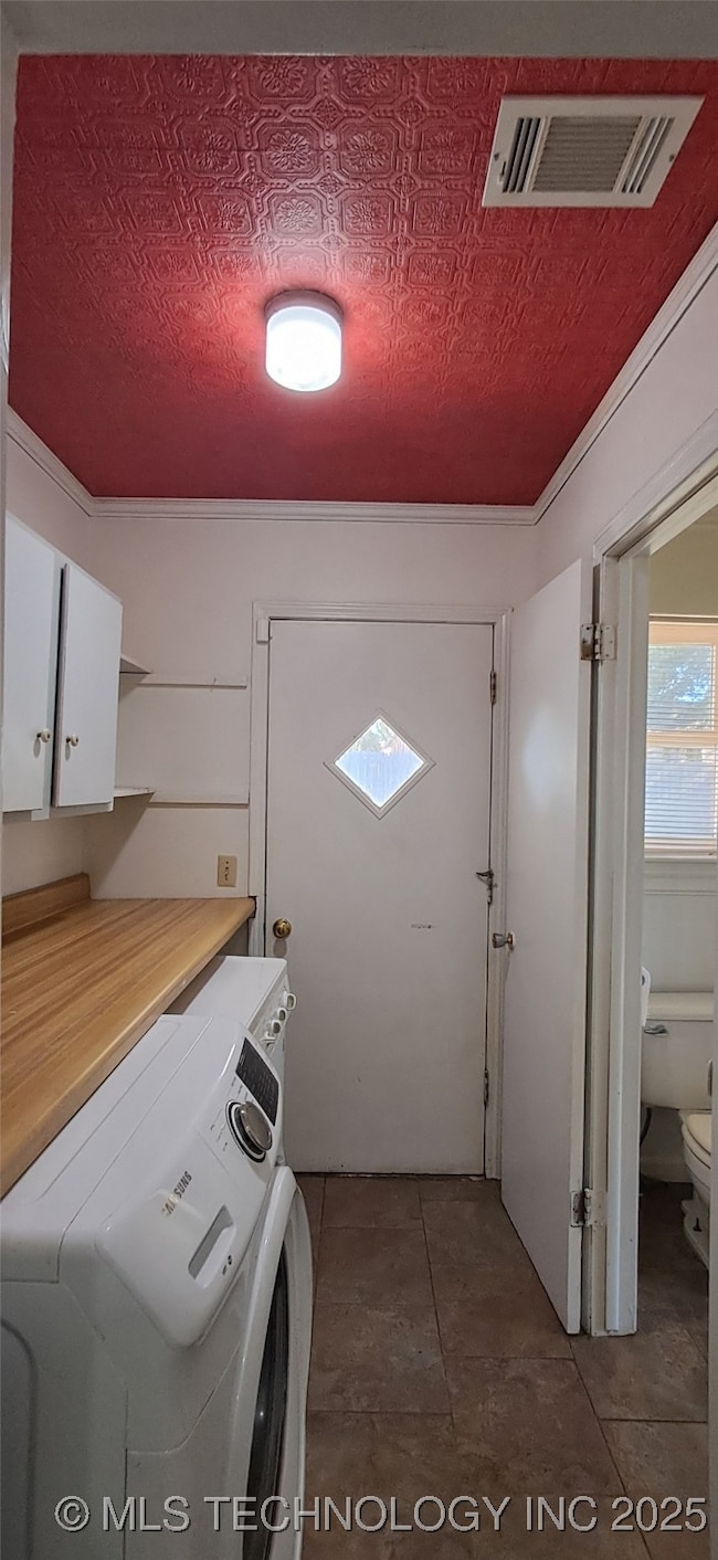Laundry room has vibrant red ceiling and access to the backyard