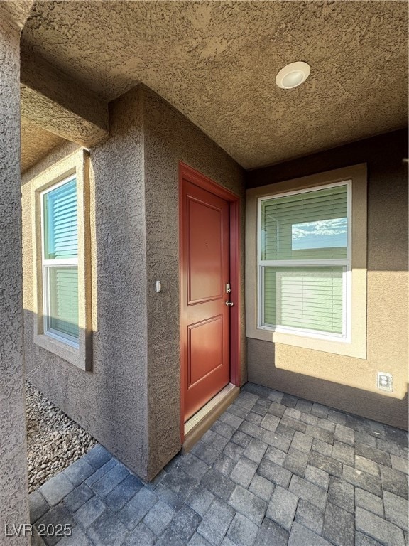 Doorway to property with stucco siding