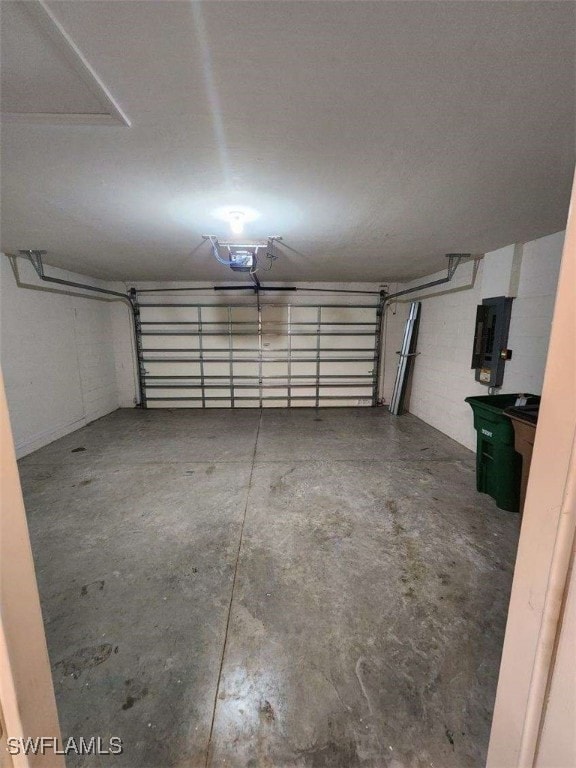 Garage featuring electric panel and concrete block