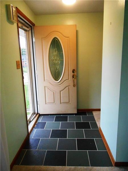Entry area with a newer front door and full length