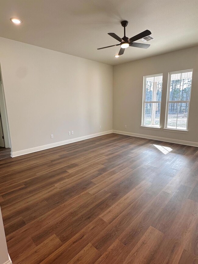 Spare room featuring ceiling fan and dark hardwood