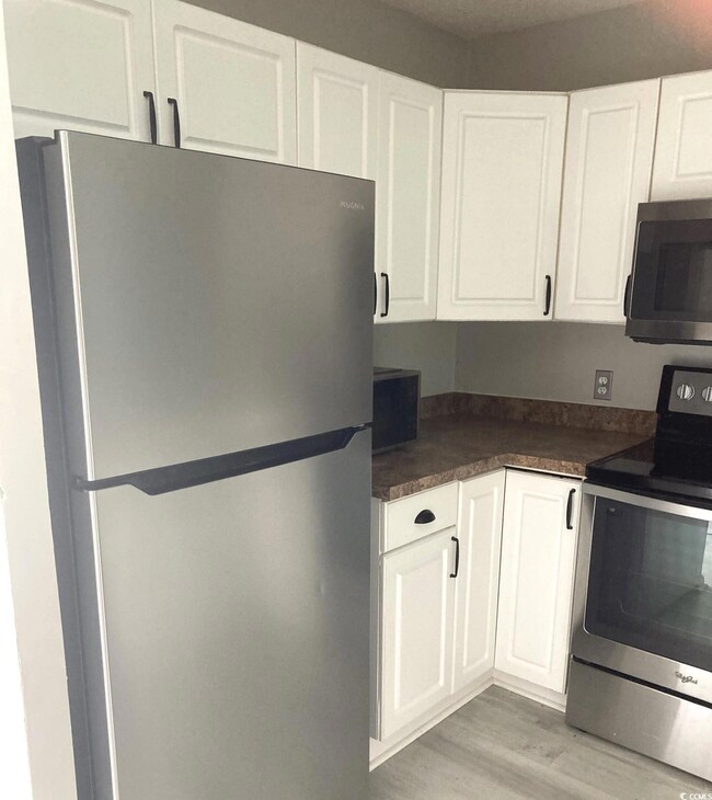 Kitchen with light hardwood / wood-style flooring,