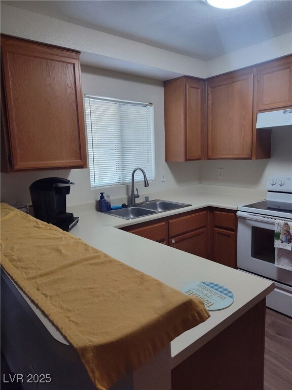 Kitchen with electric stove, under cabinet range h
