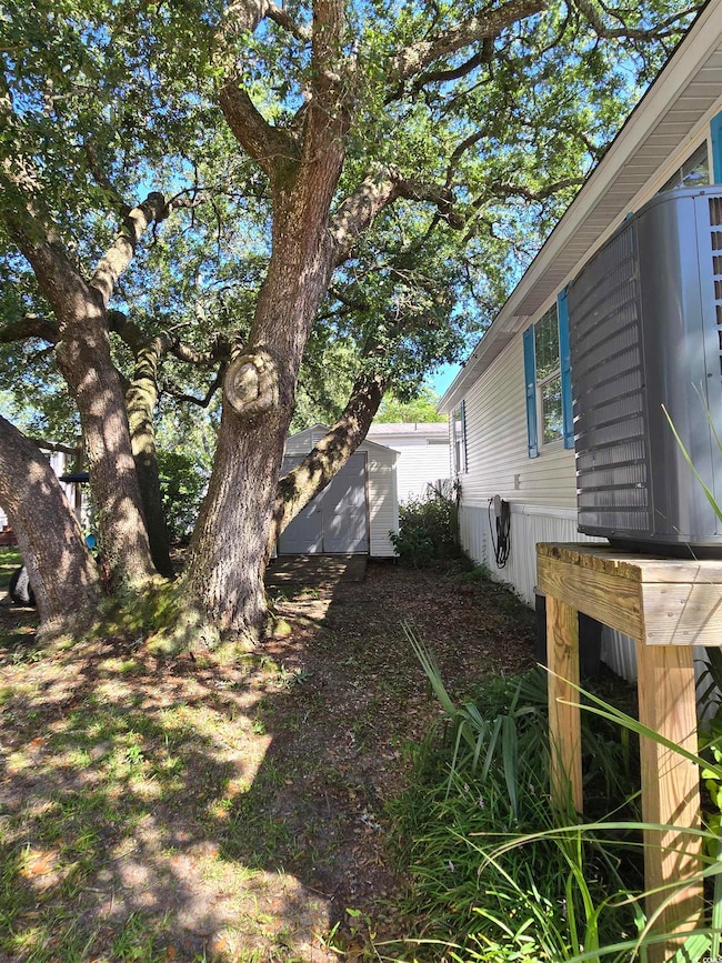 View of yard with a storage unit
