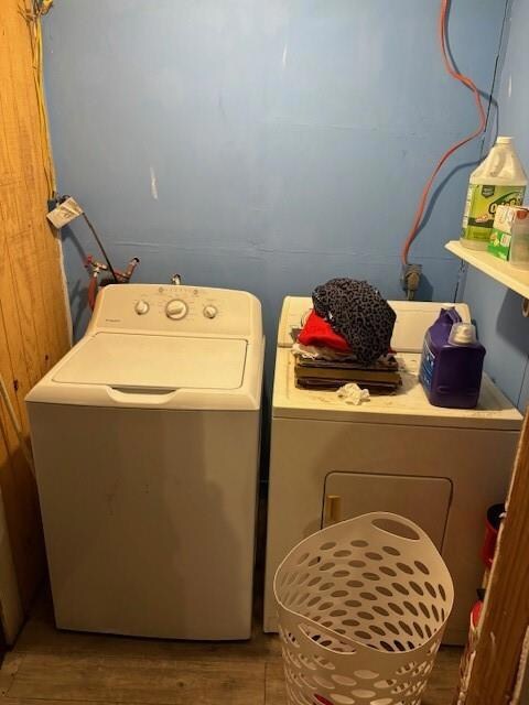 Laundry area featuring wood-type flooring and wash