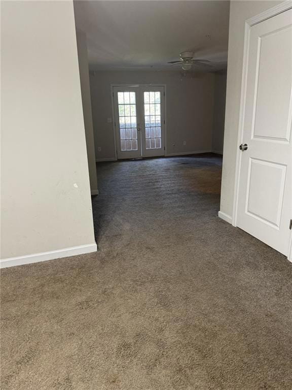 Carpeted spare room with ceiling fan and french do