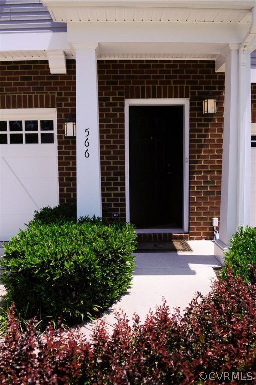 MATURE LANDSCAPE FLANKS THE ENTRANCE SIDEWALK.