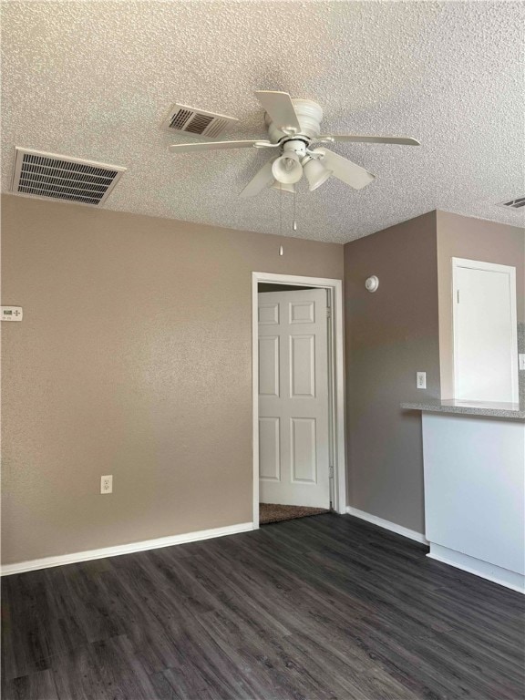 Spare room with dark wood-style floors, a ceiling
