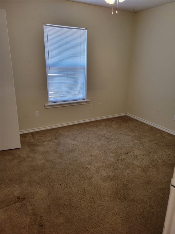 Unfurnished room with baseboards, carpet flooring,