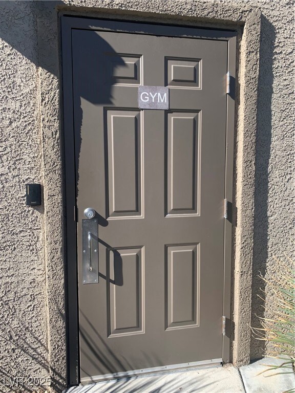 Doorway to property with stucco siding