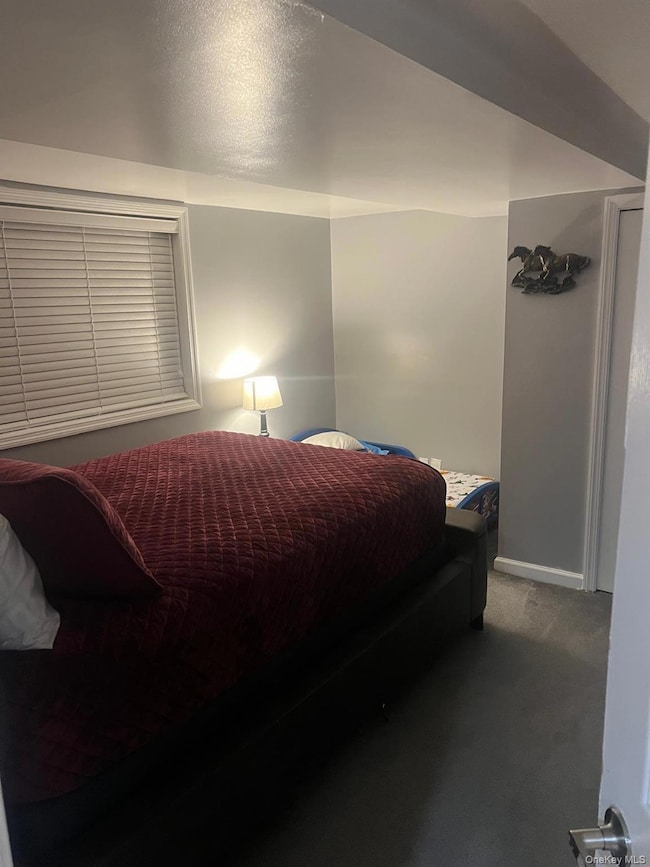 Bedroom featuring carpet flooring and a textured ceiling