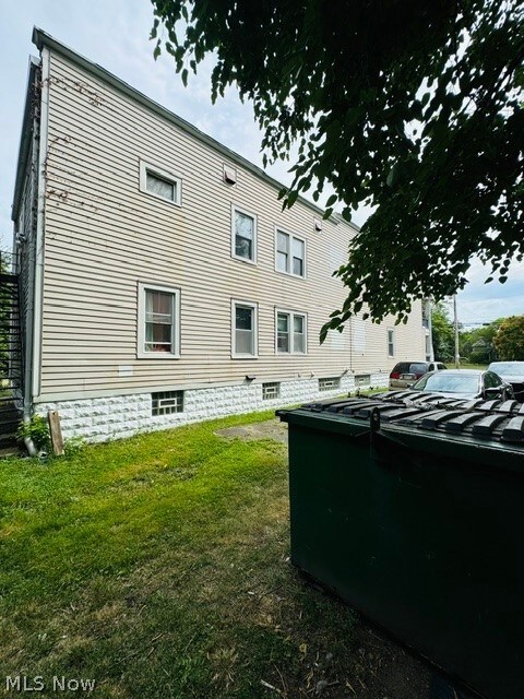 Back of property featuring a yard