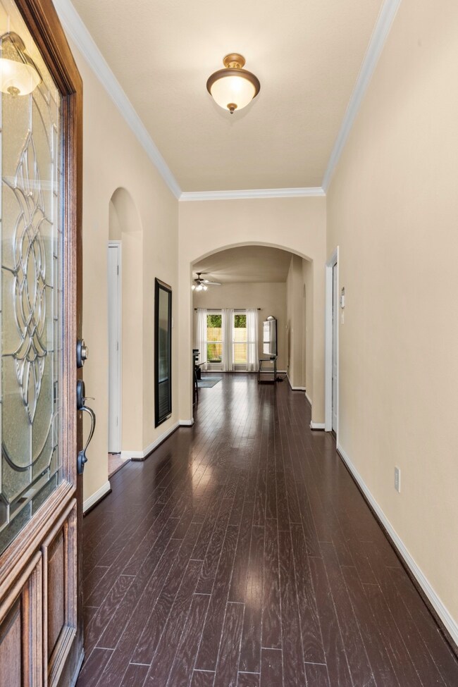 Stately foyer with hardwoods running through to the family room.